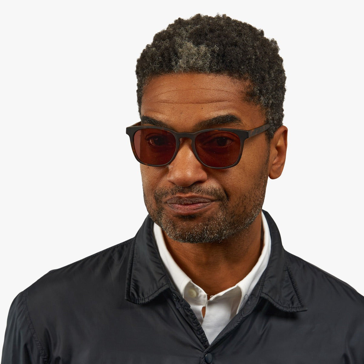 Person wearing Bornholm Dark Turtle glasses with dark oval frames