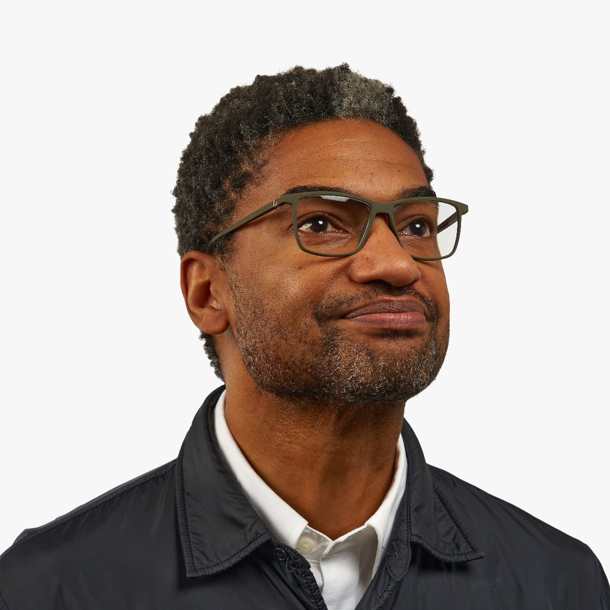 Person wearing København Dark Army glasses with a green frame