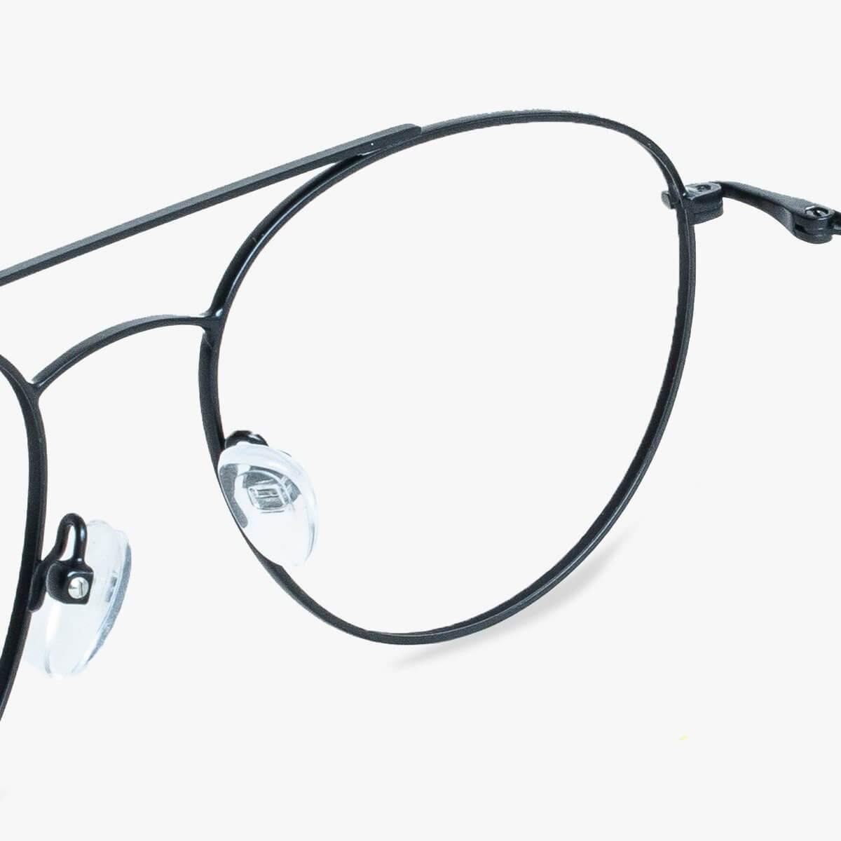 Close-up of black metal frame glasses with round lenses