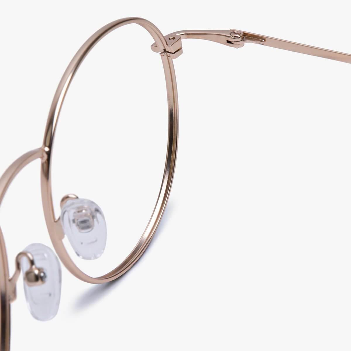 Close-up of gold metal eyeglass frame with clear nose pads